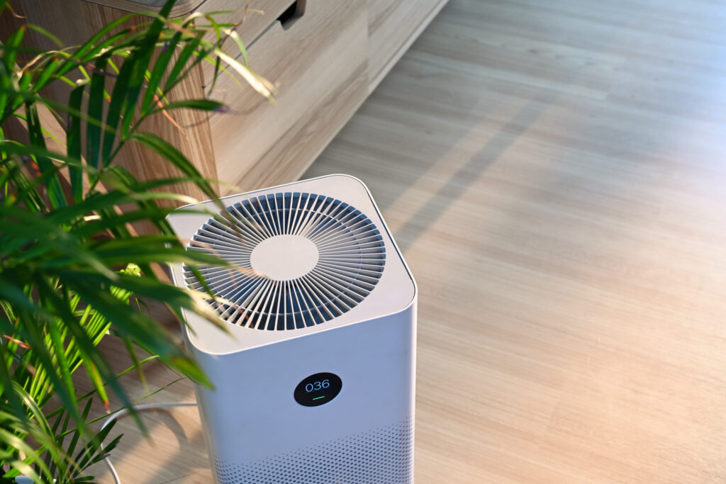 Air purifier on wooden floor in comfortable home Fresh air and healthy life